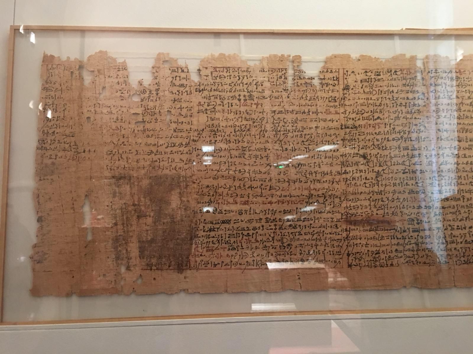A weathered Graeco Egyptian magical papyrus written in black and red ink